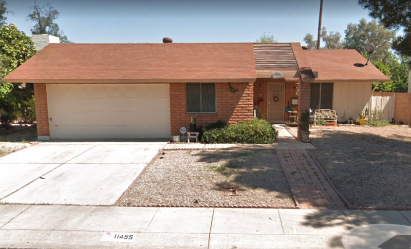 A house in suburban Phoenix with rocks in the front yard.