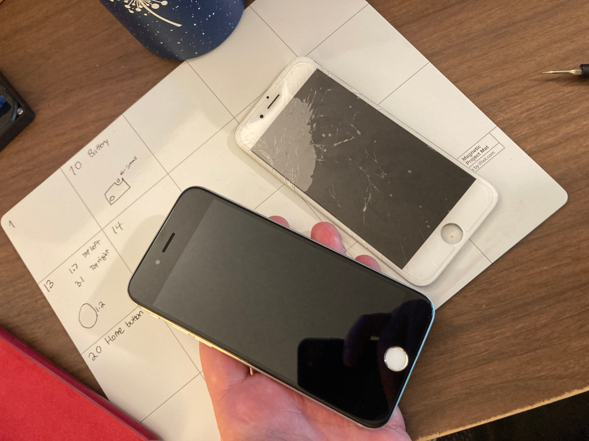 Repaired iPhone on the left and old cracked display on the right.