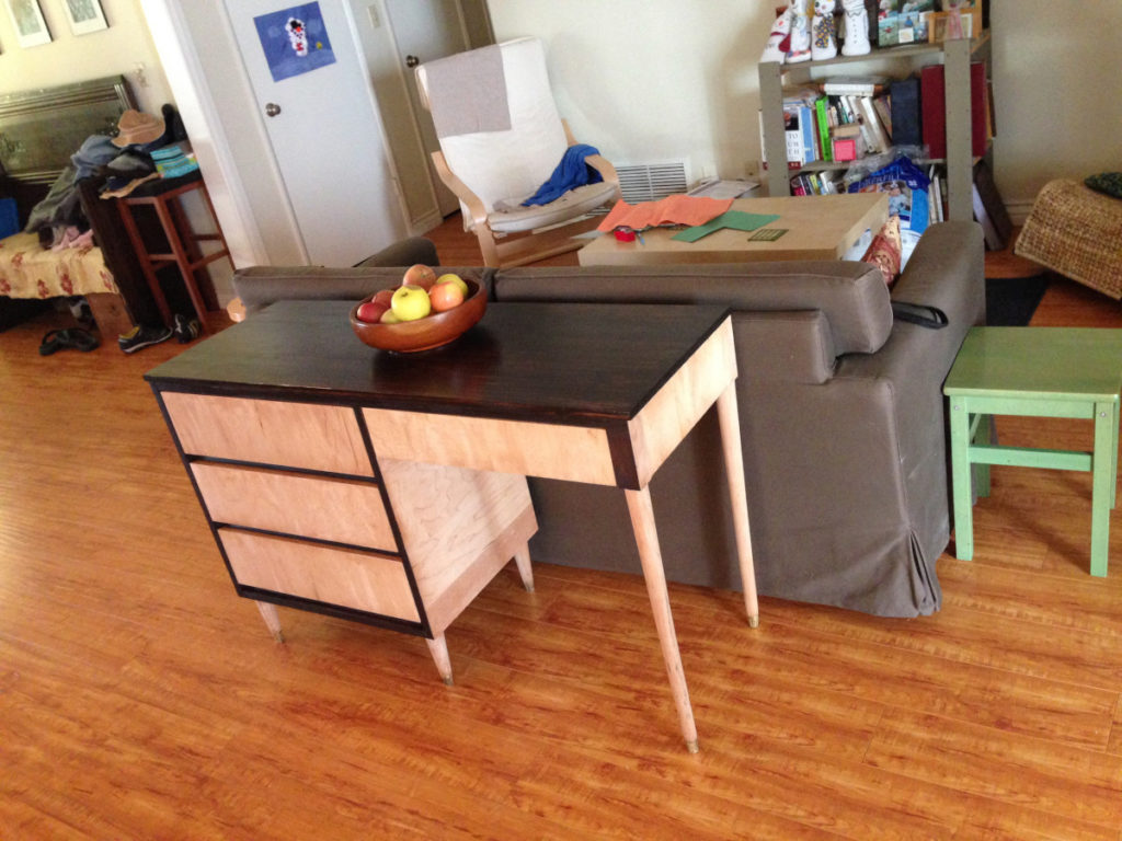 Finished desk inside a home with a bowl of fruit on top